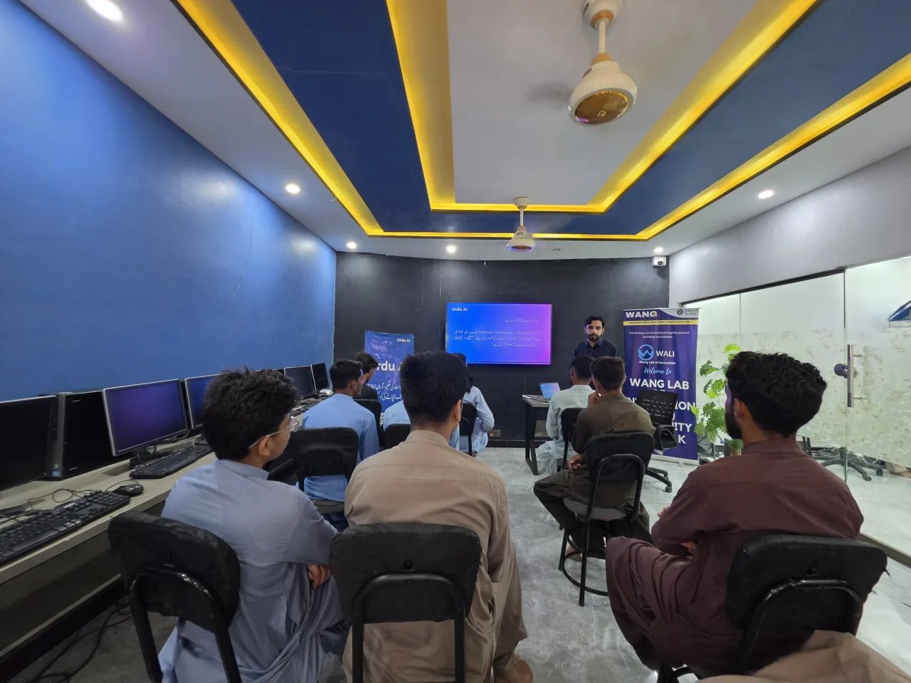 Young men attending Urdu AI session inside WALI computer lab in Balochistan