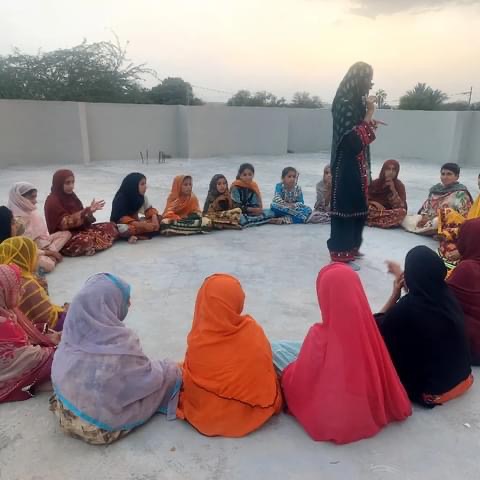 Mothers and daughters in outdoor learning circle in rural Balochistan WIRE program